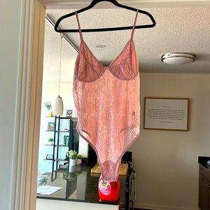 Cider new, never worn pink lace bodysuit. Size large.